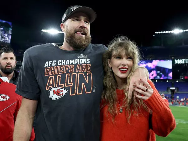 Travis Kelce and Taylor Swift celebrate the Chiefs' AFC Championship win.