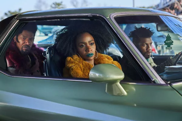 Jamie Foxx, Teyonah Parris, and John Boyega in 'They Cloned Tyrone.' Parrish Lewis/Netflix