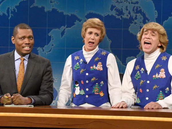 Michael Che, Kristen Wiig as Kat, and Fred Armisen as Garth during Weekend Update in 2014. Dana Edelson/NBCU Photo Bank/NBCUniversal/Getty Images